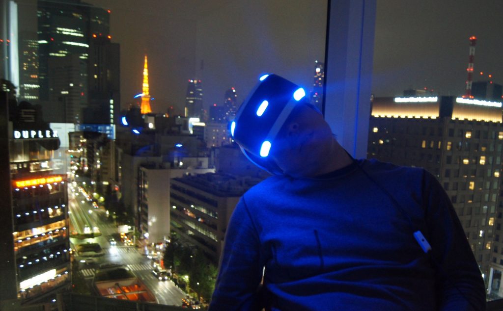 夜景をバックにVRの世界に没入するgreenspa氏。